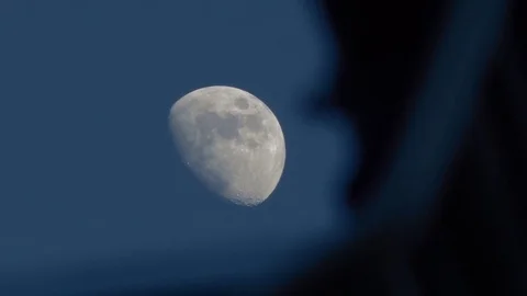 Moon moving behind a moving object timelapse Stock Footage 81097912