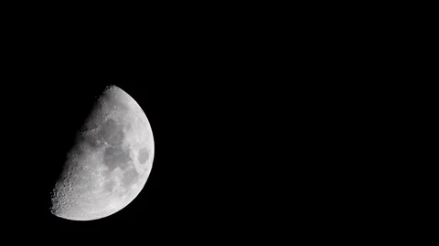 The moon moving in night sky during the waxing gibbous phase Stock Footage 147990242