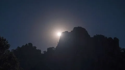 Moon moving over rock mountain time lapse Stock Footage 148606436