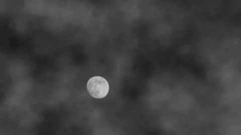The moon moving over a static cloud at midnight Stock Footage 168652127