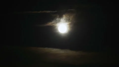 Moon at night with illuminated cloud cover and dark sky Stock Footage 154746362