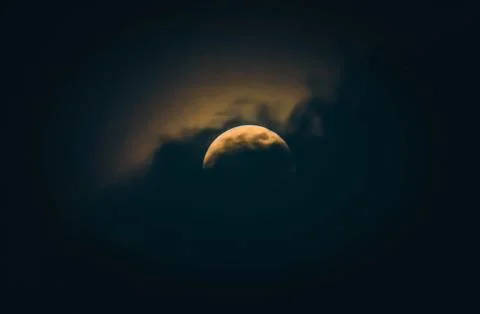 Moon at night partially covered by the cloud. Full moon with clouds dramatic  Stock Photos