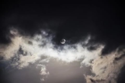 The moon in the night sky in clouds Stock Photos