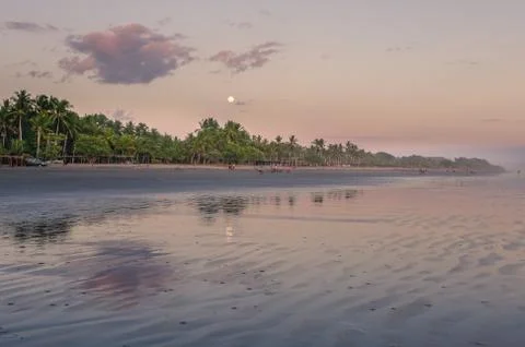 Moon over the beach at a sunset Stock Photos