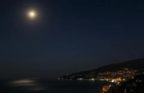 The moon over the coast. Stock Photos