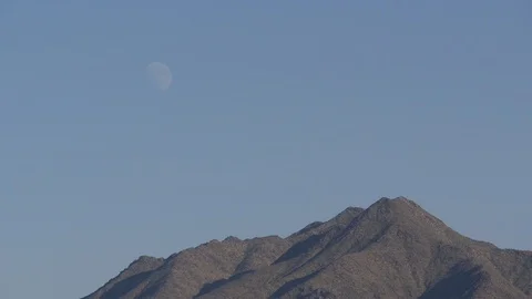 Moon over desert mountains - daytime Stock Footage 99993777
