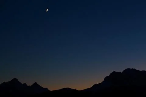 Moon over mountain range at night Stock Photos