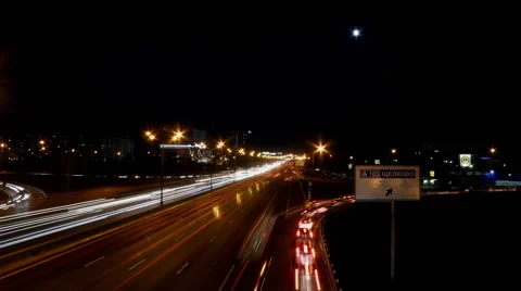 Moon over night highway time lapse Stock Footage 64308178