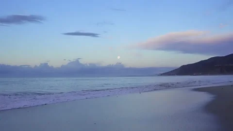 Moon over ocean. Beach at eye level. 4K Stock Footage 194157955