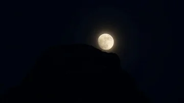 Moon over a rock in the night Video stock 85520935
