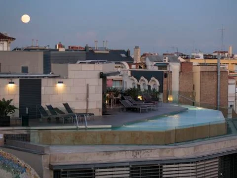 Moon over rooftop pool Stock Photos