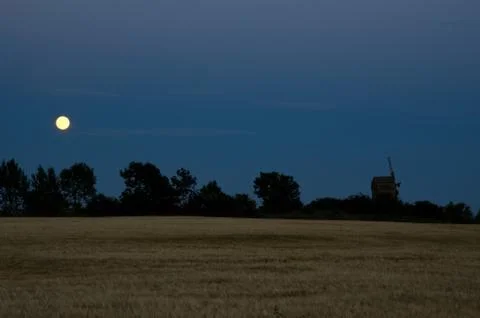Moon over windmill and a cornfield Stock Photos