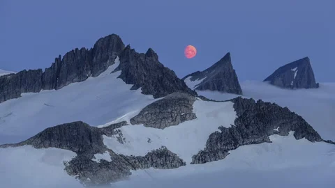 Moon passes over the mountain tops Stock Footage 250432987