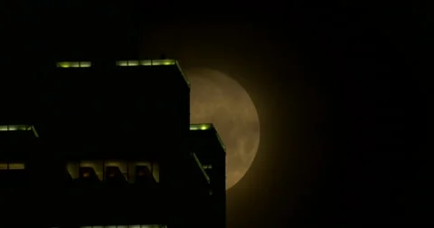 Moon passing behind skyscraper in downtown Atlanta, GA 04-02-2015 Stock Footage 48862611