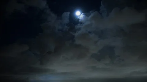 Moon peeps between billowing storm clouds timelapse 8K Stock Footage 108395052