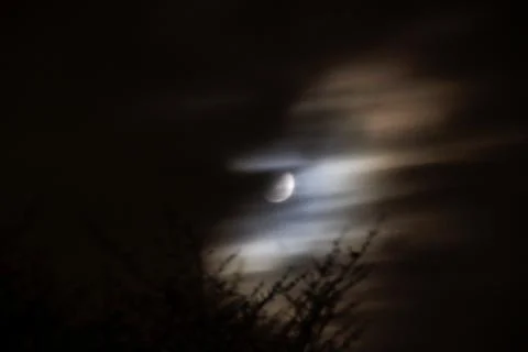 Moon poking out from behind clouds Foto stock
