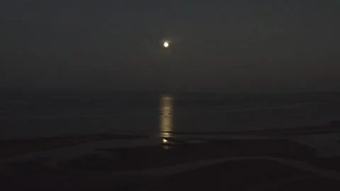 Moon reflecting on the sea forward drone shot Stock Footage 247404774
