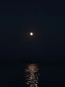 The moon reflecting from the sea Stock Photos