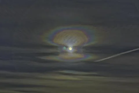 Moon reflections on cloudy sky Stock Photos