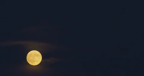 The Moon Rises and weaves in and out of the clouds. Stock Footage 95906162