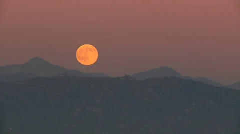 Moon Rises behind mountains - Time lapsed Stock Footage 7530122