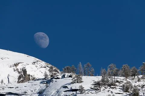 The moon rises over Half Dome at Yosemite park Stock Photos