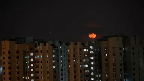 Moon rising and obscured by clouds Stock Footage 128166531