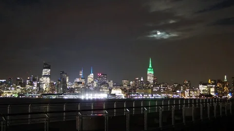 The Moon Rising behind Clouds over the Manhattan Skyline Stock Footage 71131090