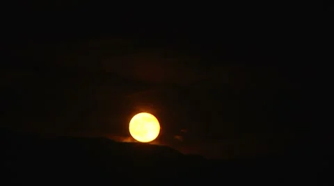 Moon rising behind mountains Stock Footage 7138253