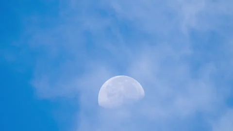Moon Rising in Blue Sky with Clouds Timelapse Stock Footage 317738589