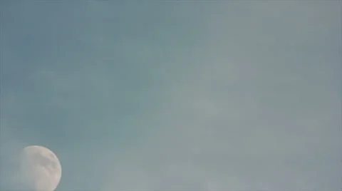 Moon rising mid-afternoon through light cloud cover- Time Lapsed 4K Stock Footage 34334440