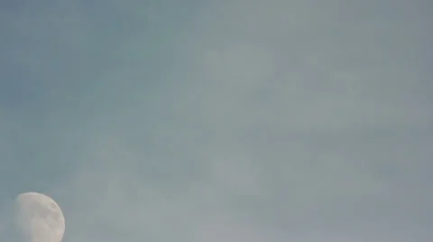 Moon rising mid-afternoon through light cloud cover- Time Lapsed Stock Footage 34334503
