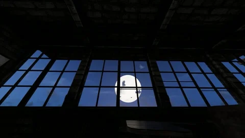 The moon rising outside the window of the old classroom at night Stock Footage 320666524
