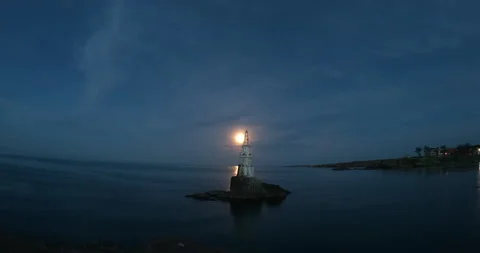 Moon rising over a lighthouse at the Black sea -  timelapse Stock Footage 133258556