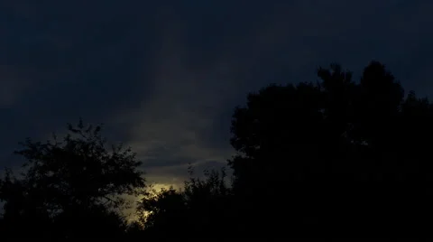 Moon Rising over Trees with Clouds Stock Footage 68854108
