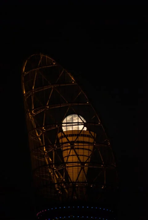Moon rising from the torch tower Stockbeeldmateriaal 164382131