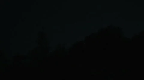 Moon rising up from the tree's crown silhuette Stock Footage 52930613