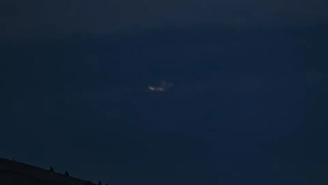 Moon Setting Behind Dark Dramatic Clouds in Night Sky, Time Lapse Stock Footage 321494742