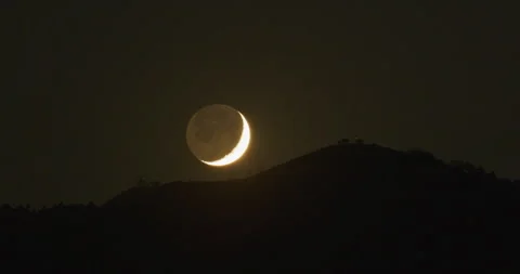Moon setting behind mountain night time lapse Stock Footage 249236903