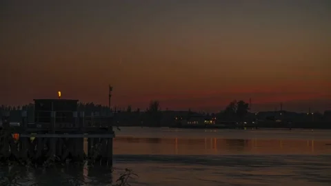 Moon setting down behind river Schelde and Antwerpen port buildings, night Stock Footage 162661297
