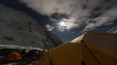 Moon setting with racing clouds and tent from camp 2 on Everest Stock-Footage 122092317