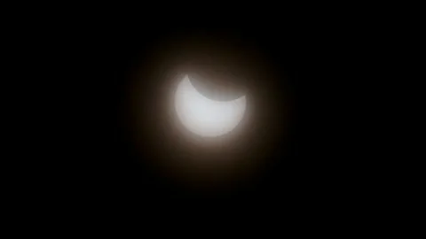 Moon shadow passing in front of bright glowing sun in solar eclipse event 2025 Stock Footage 305662868