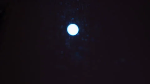 The moon shines bright on a cold dark night and shows the water drip on the Stock Footage 331669108