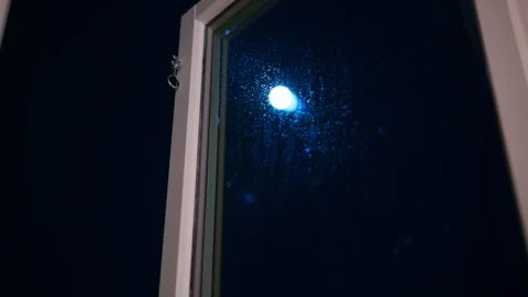 The moon shines bright on a cold dark night and shows the water drip on the Stock Footage 331669461