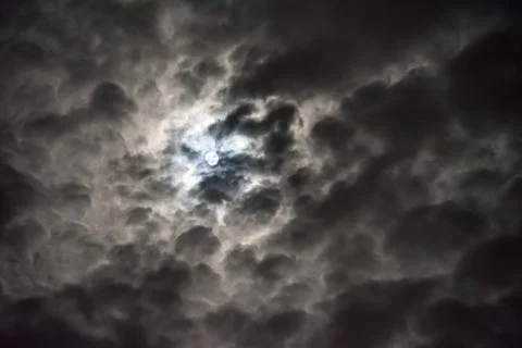 Moon Shines through the Clouds Cloudy Night Background Stock Photos