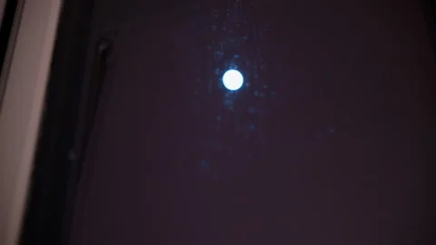 The moon shines through the window on a dark cold night Stock Footage 331669193