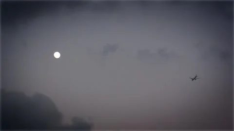 Moon in the sky and flying plane near Stock Footage 40014380