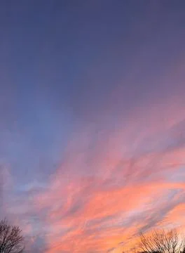 The moon is slightly visible through the clouds. Stock Photos