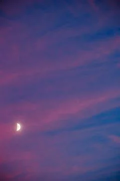 Moon at sunset between pink clouds in Alhambra Stock Photos