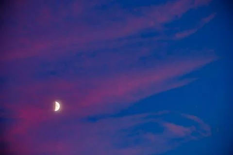 Moon at sunset between pink clouds in Alhambra Stock Photos